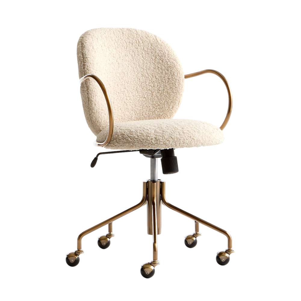 Close-up of the caster wheels and brass-tone base on Crate & Barrel Luna Ivory Boucle Upholstered Office Chair