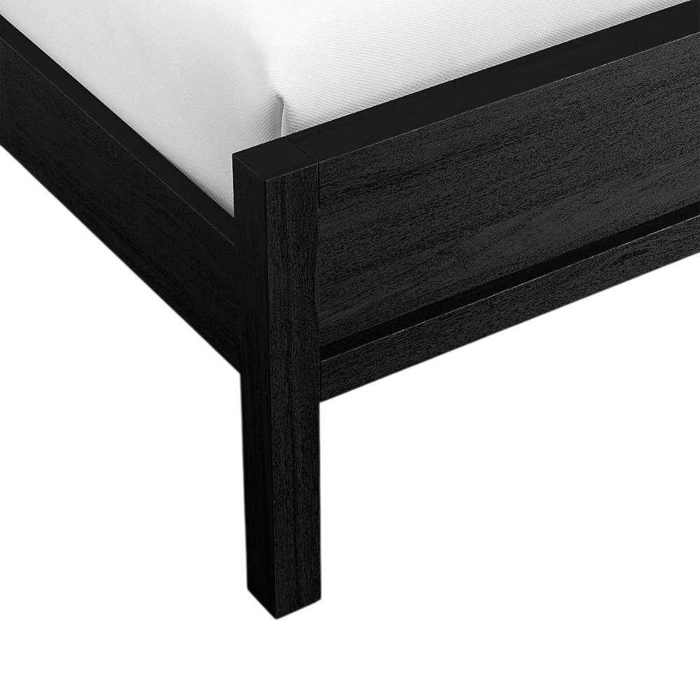 Close-up of the corner leg and footboard on Crate & Barrel Keane Black Solid Wood Queen Bed highlighting the black wood grain