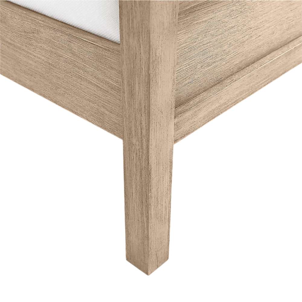 Close-up of the corner leg and footboard on Crate & Barrel Keane Weathered Natural Solid Wood Queen Bed highlighting the natural wood grain