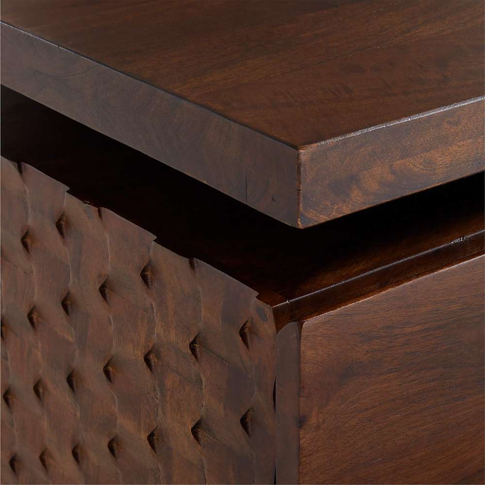 Close-up of the corner of Crate & Barrel Raffael Carved Wood Executive Desk highlighting the thick wood top and carved side detail