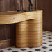 Close-up of the curved ribbed wood base and seamless drawer on Crate & Barrel Delphine 73" Storage Console Table Desk