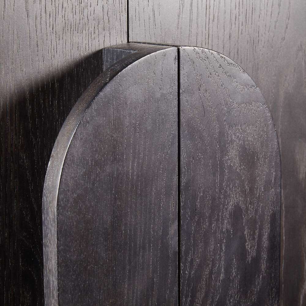 Close-up of the curved wood handle detail on the Crate & Barrel Annie 38" Charcoal Brown Storage Cabinet
