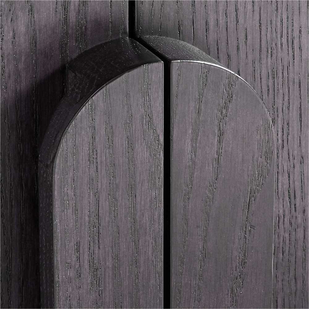 Close-up of the curved wood handles on Crate & Barrel Annie 38" Charcoal Brown Wood Storage Bookcase with Shelves