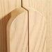 Close-up of the curved wood handles on Crate & Barrel Annie 38" Natural Wood Storage Bookcase with Shelves