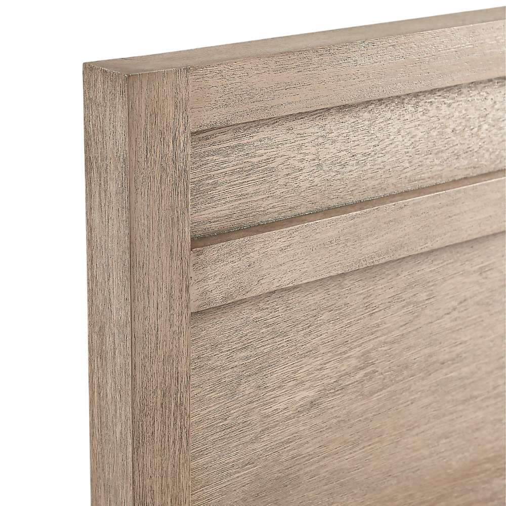 Close-up of the headboard on Crate & Barrel Keane Weathered Natural Solid Wood Queen Bed showing its textured wood grain and simple modern design