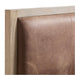 Close-up of the leather upholstered headboard on Crate & Barrel Keane Weathered Natural Wood and Leather Queen Bed with a weathered natural wood frame