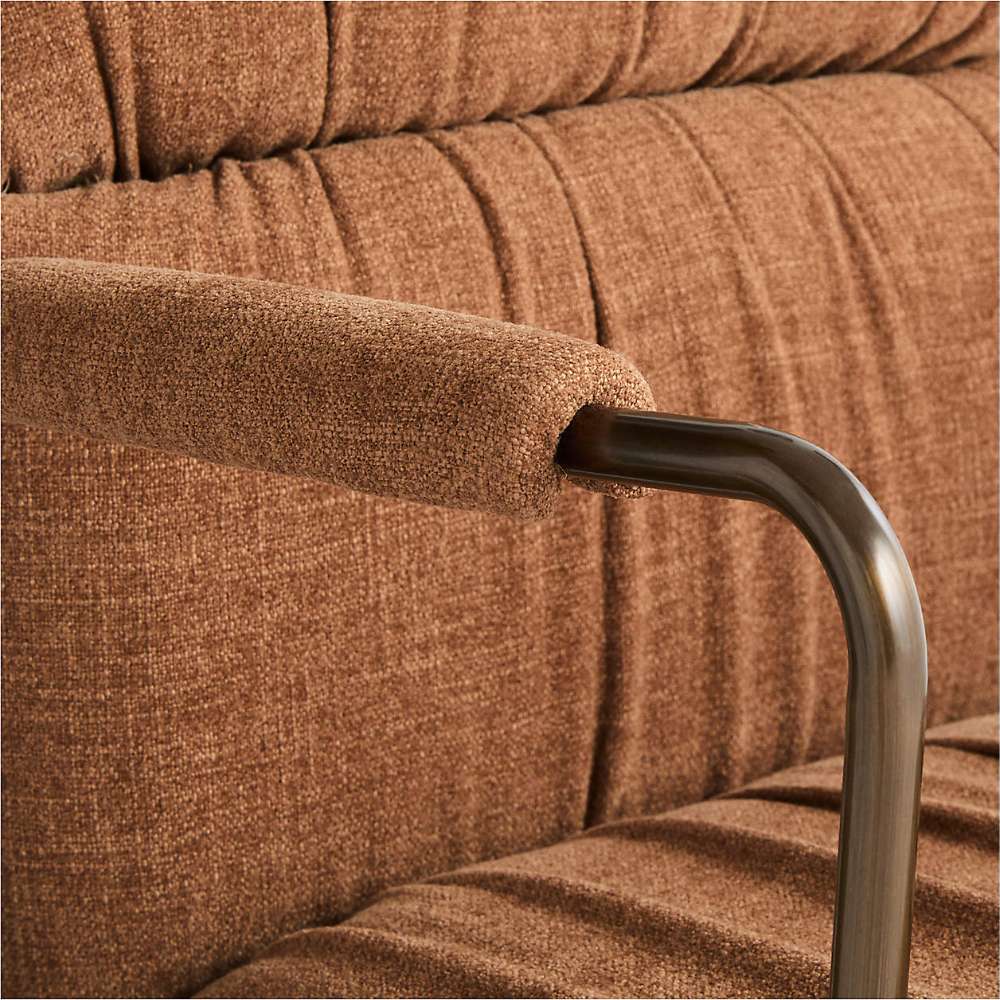 Close-up of the padded armrest and textured ginger fabric on Crate & Barrel Draper Ginger Upholstered Office Chair