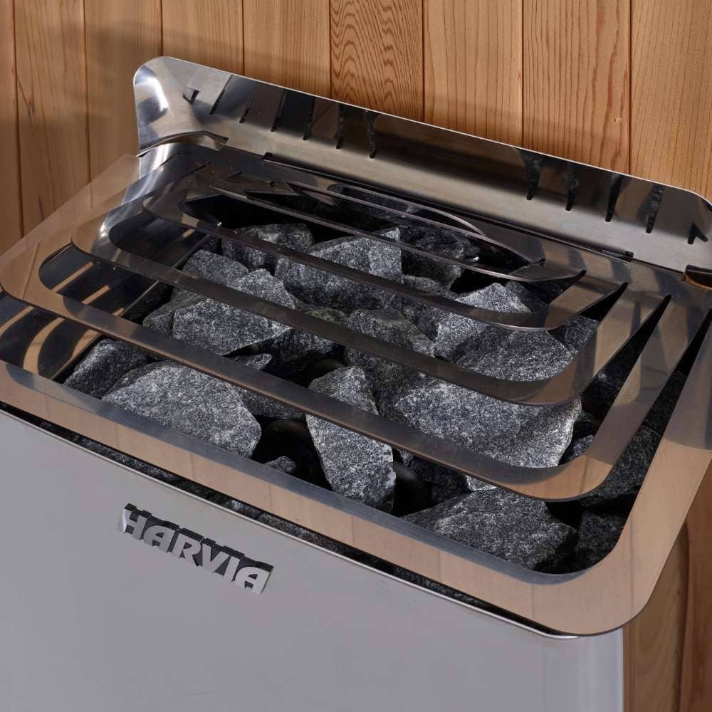 Close-up of the stainless steel stove in Golden Designs Forssa 3-4 Person Traditional Sauna with gray sauna stones resting under steel guard rails
