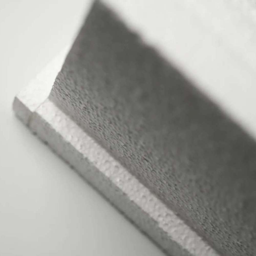 Close-up of the textured edge and recessed channel of a white GIK Acoustics GridFusor™ Diffuser, highlighting its sound-scattering design