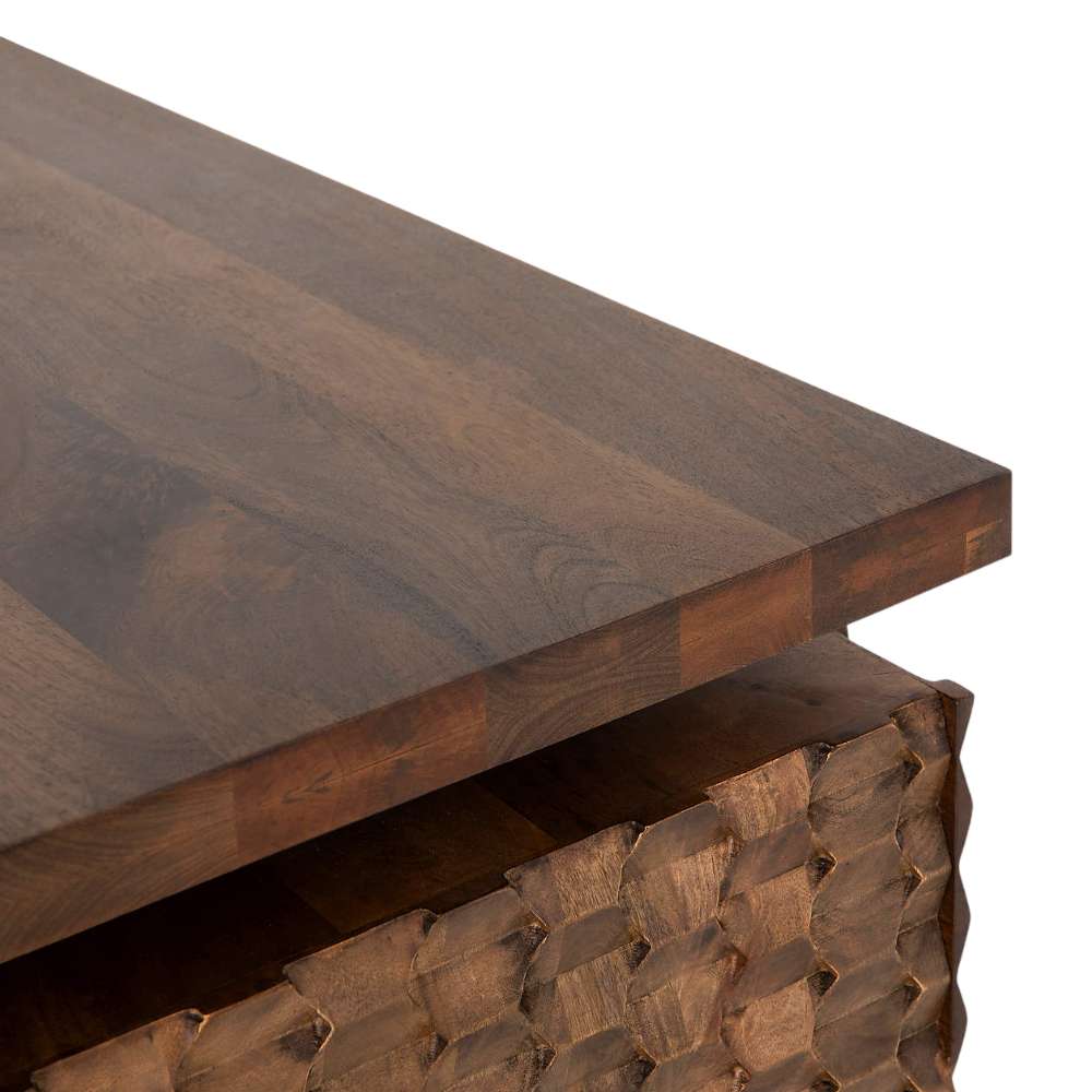 Close-up of the thick wood top and carved side panel on Crate & Barrel Raffael Carved Wood Executive Desk with a rich brown finish
