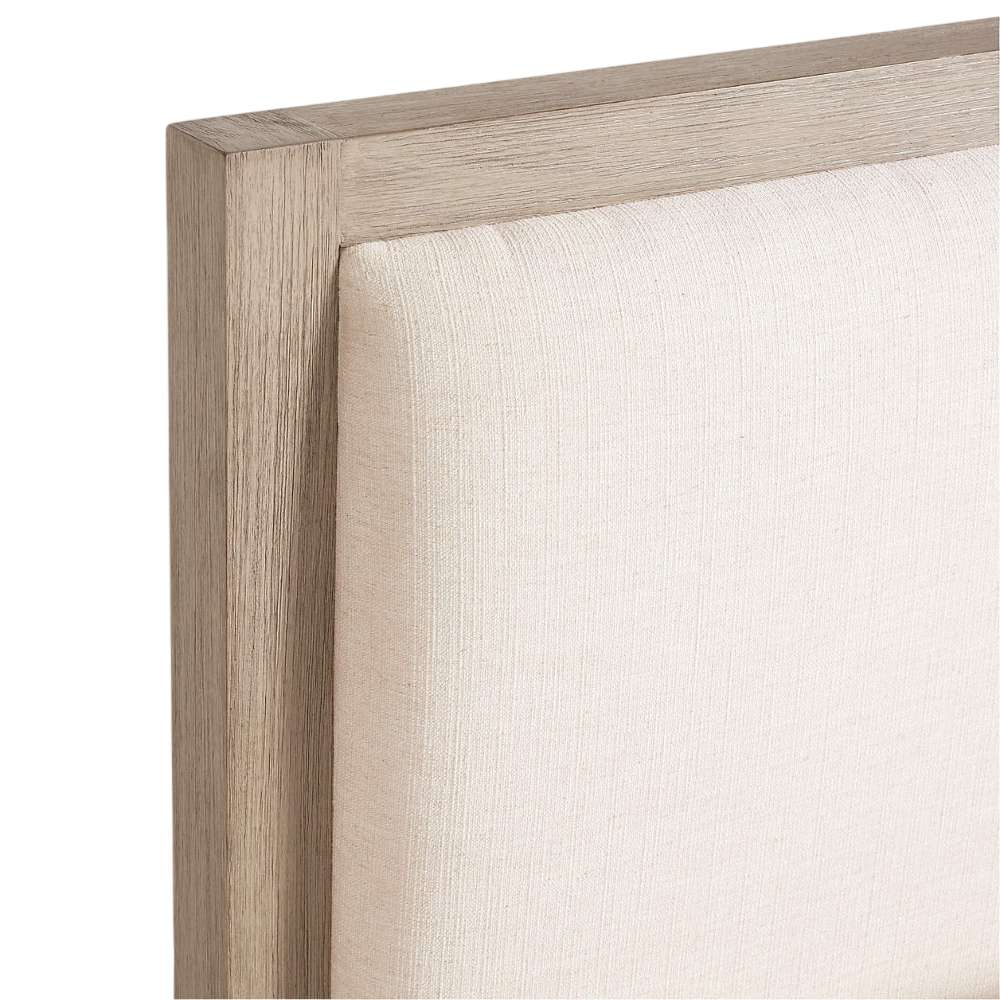 Close-up of the upholstered headboard on Crate & Barrel Keane Weathered Natural Wood Upholstered Queen Bed with a weathered natural wood frame