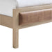 Close-up of the wood frame and leather footboard panel on Crate & Barrel Keane Weathered Natural Wood and Leather Queen Bed