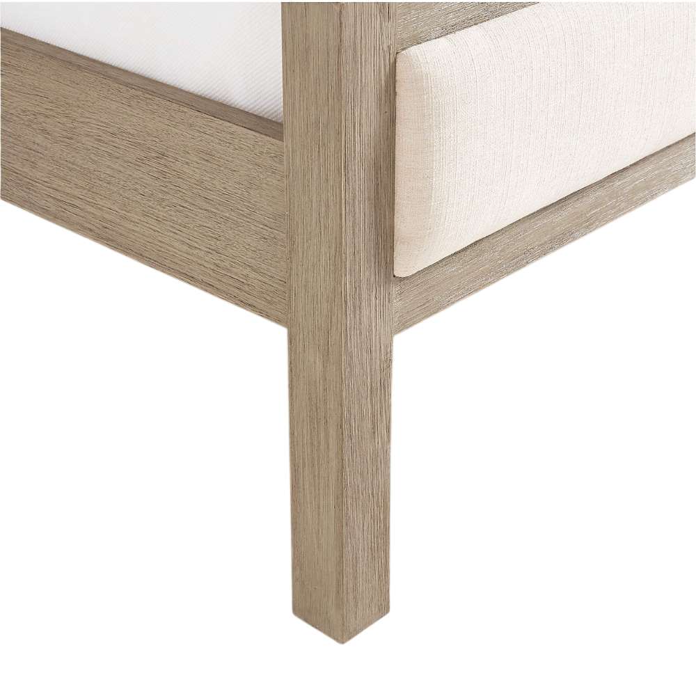Close-up of the wood leg and corner frame on Crate & Barrel Keane Weathered Natural Wood Upholstered Queen Bed highlighting its weathered natural finish