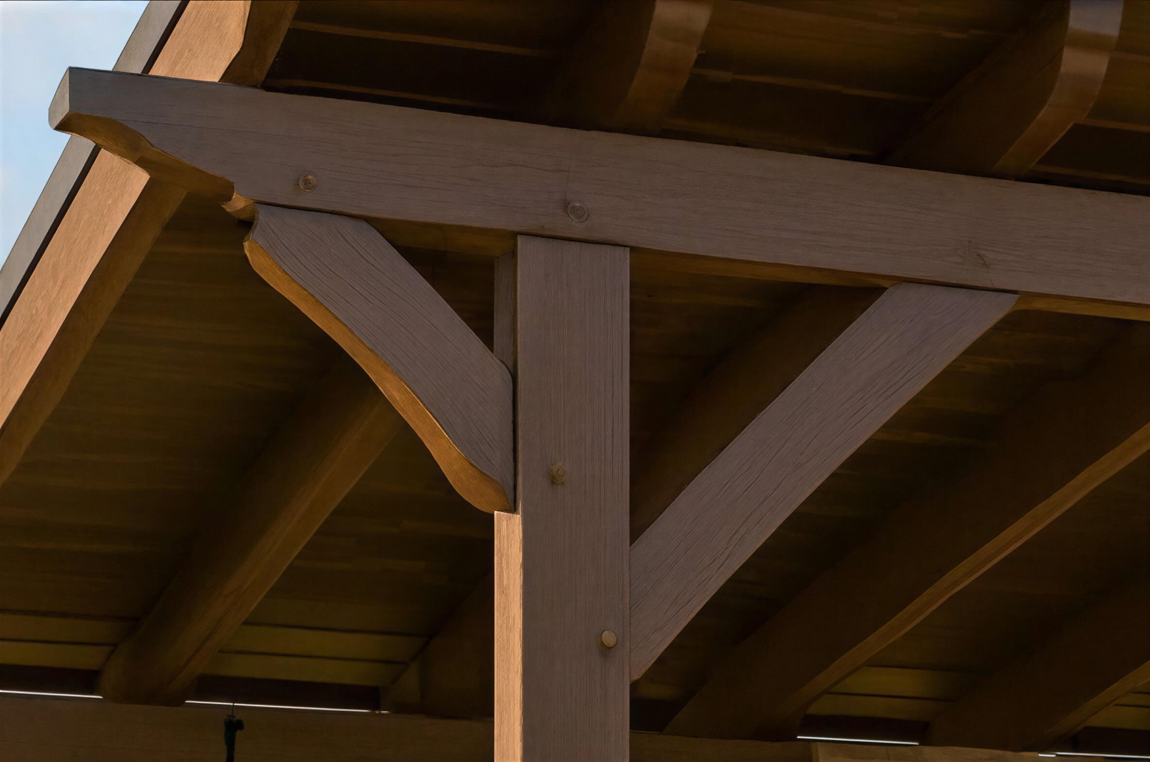 Close-up of wooden beams and braces on the Brookside Timber Frame Ridgeview Pavilion roof