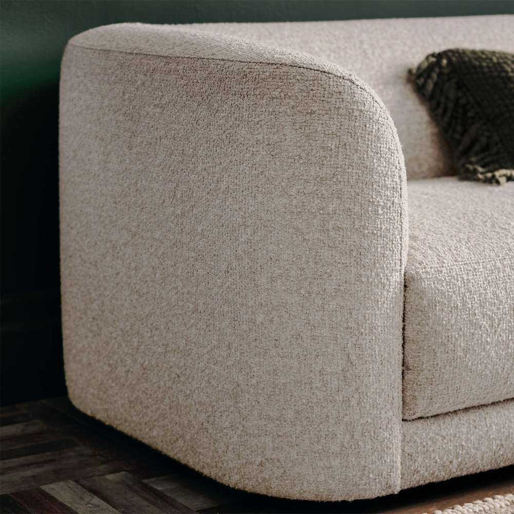 Close-up side view of Crate & Barrel Contour Sofa showcasing its rounded armrest and textured upholstery