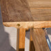 Close-up view highlights the smooth wooden edge and metal hardware detail of Westminster Teak Horizon Table & Bench Set