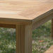 Close-up view of the corner of Westminster Teak 6ft Horizon Teak Backless Bench shows smooth teak wood grain and solid leg construction