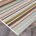 Close-up of Couristan Dolce Indoor/Outdoor Rug - Striped/Sunset shows its colorful horizontal stripe pattern with textured weaves