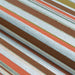 Close-up of Couristan Dolce Indoor/Outdoor Rug - Striped/Sunset shows its folded surface