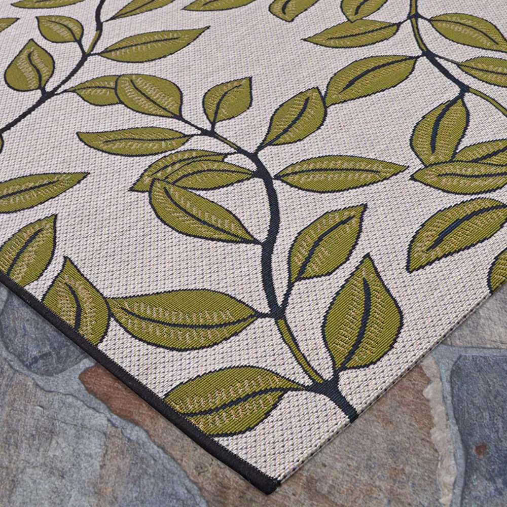 Close-up of Couristan Dolce Indoor/Outdoor Rug - Summer Ivy/Ivory-Olive shows a beige woven texture with bold olive-green leaves outlined in black