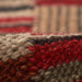 Close-up of Momeni Adobe Indoor Rug - ADO-1 Red reveals its thick, handwoven texture in earthy tones of red, tan, and brown