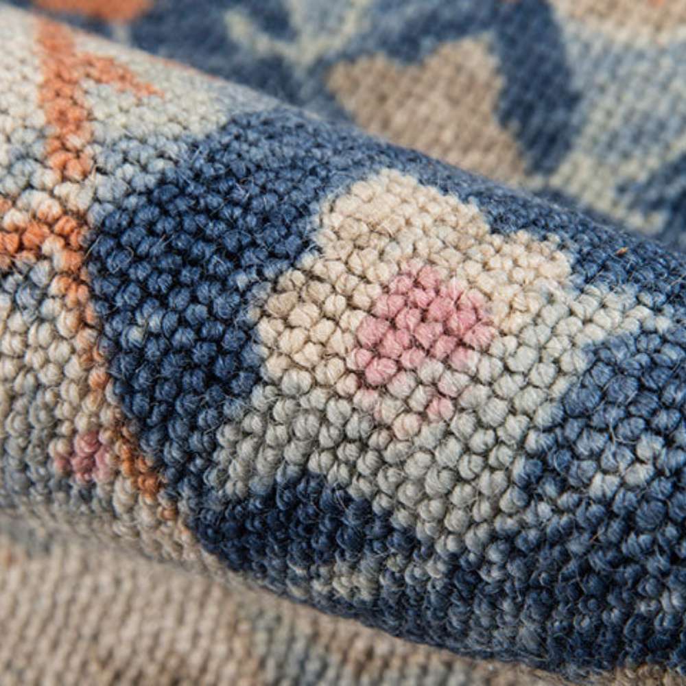 Close-up of Momeni Anatolia Indoor Rug - ANA-8 Navy shows its tightly woven floral pattern with hints of pink and orange accents