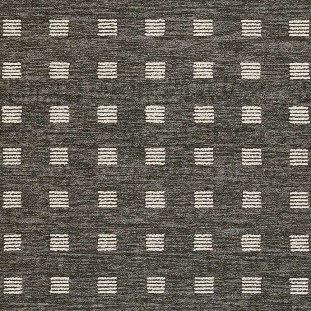 Close-up of Momeni Archer Indoor Rug - ARC-1 Charcoal shows its flexible, soft material with a sturdy edge finish