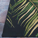 Close-up of corner of Couristan Dolce Indoor/Outdoor Rug - Bamboo Forest/Cool Onyx reveals clean stitching and a realistic palm leaf pattern