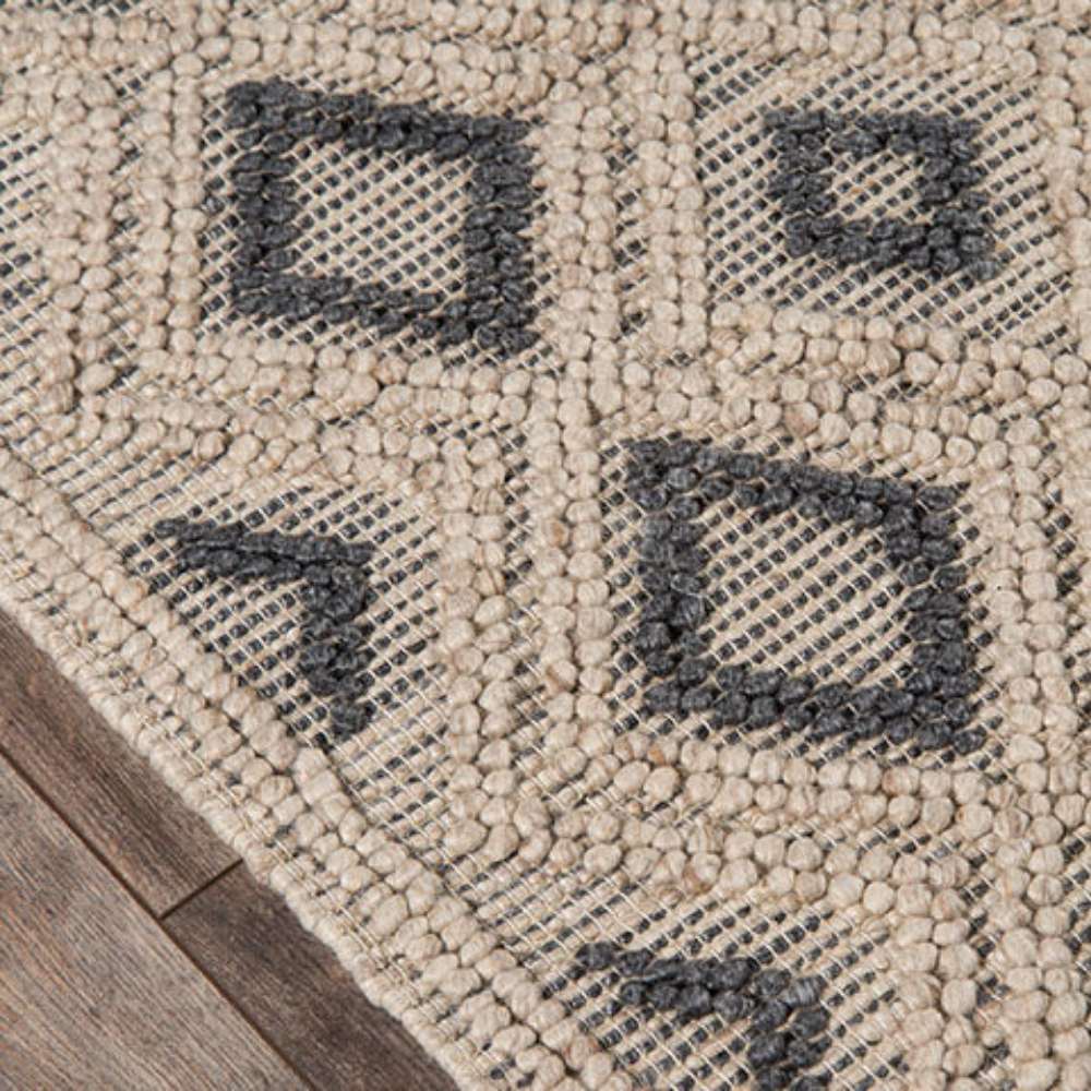 Close-up of the Momeni Andes Indoor Rug - AND-2 Beige shows its handwoven wool texture and geometric diamond detailing