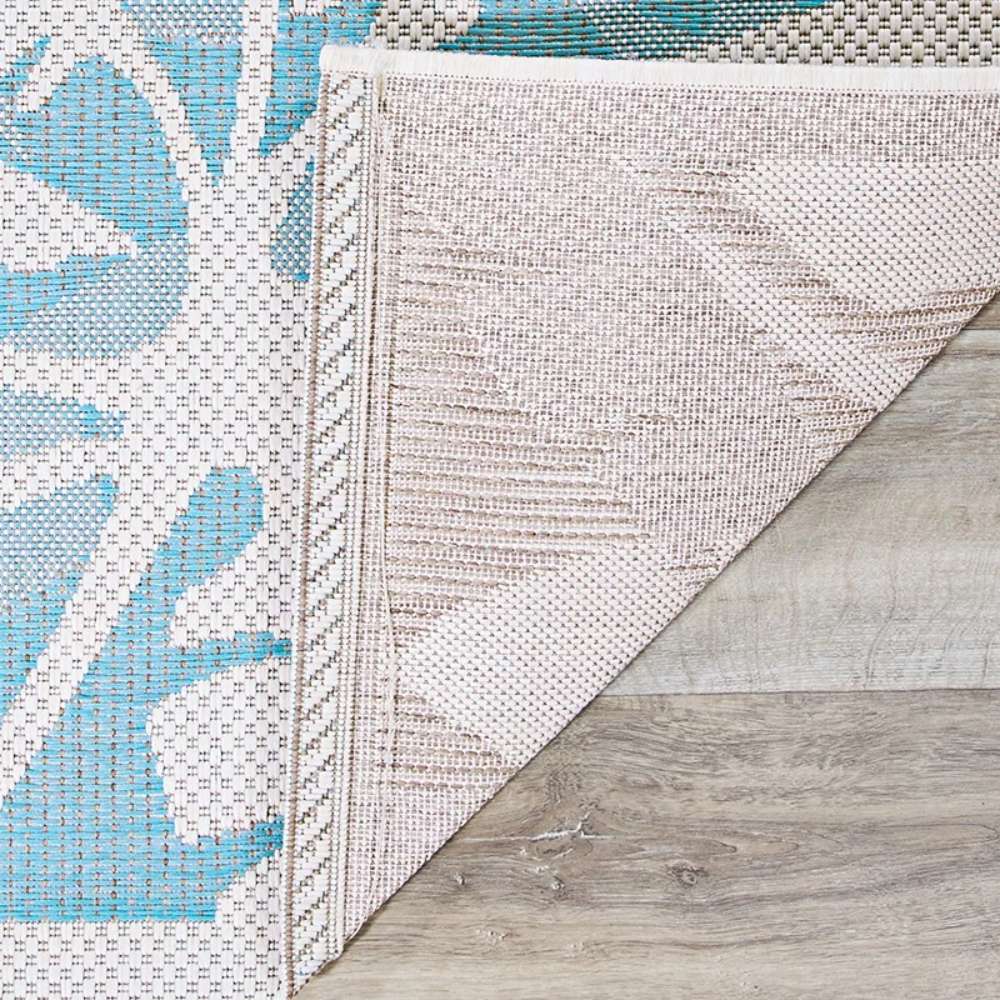 Close-up of the corner backing shows the durable weave of Couristan Monaco Indoor/Outdoor Rug - Coastal Flora/Ivory-Turquoise