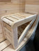 Close-up of the corner bench on the front porch of Sawmill Structures Box Sauna showcasing its slatted design and curved edge