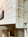 Close-up of the corner joint on the Sawmill Structures Grand Loft 107 Deluxe DD Garden Room reveals interlocking woodwork with smooth, unfinished timber panels