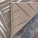 Close-up of the flipped corner of Couristan Dolce Indoor/Outdoor Rug - Parquet/Mocha shows the neat stitching and dual-tone design on the underside