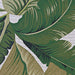 Close-up of the leaf pattern on Couristan Dolce Indoor/Outdoor Rug - Palm Lily/Hunter Green-Ivory shows intricate design and rich green tones