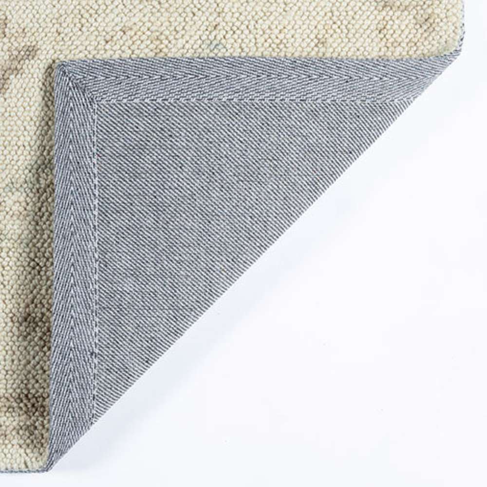 Close-up of the underside of Momeni Anatolia Indoor Rug - ANA-5 Beige shows its sturdy backing