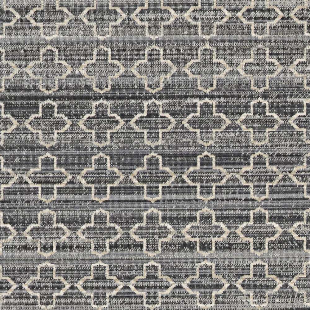 Close-up pattern shot of Couristan Fez Indoor/Outdoor Rug - Riad/Tobacco displays cream geometric shapes over a textured gray and black background