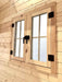 Close-up shows a sturdy double-pane wooden window with black hardware inside the Sawmill Structures Multi Cube Versa 100 Garden Room