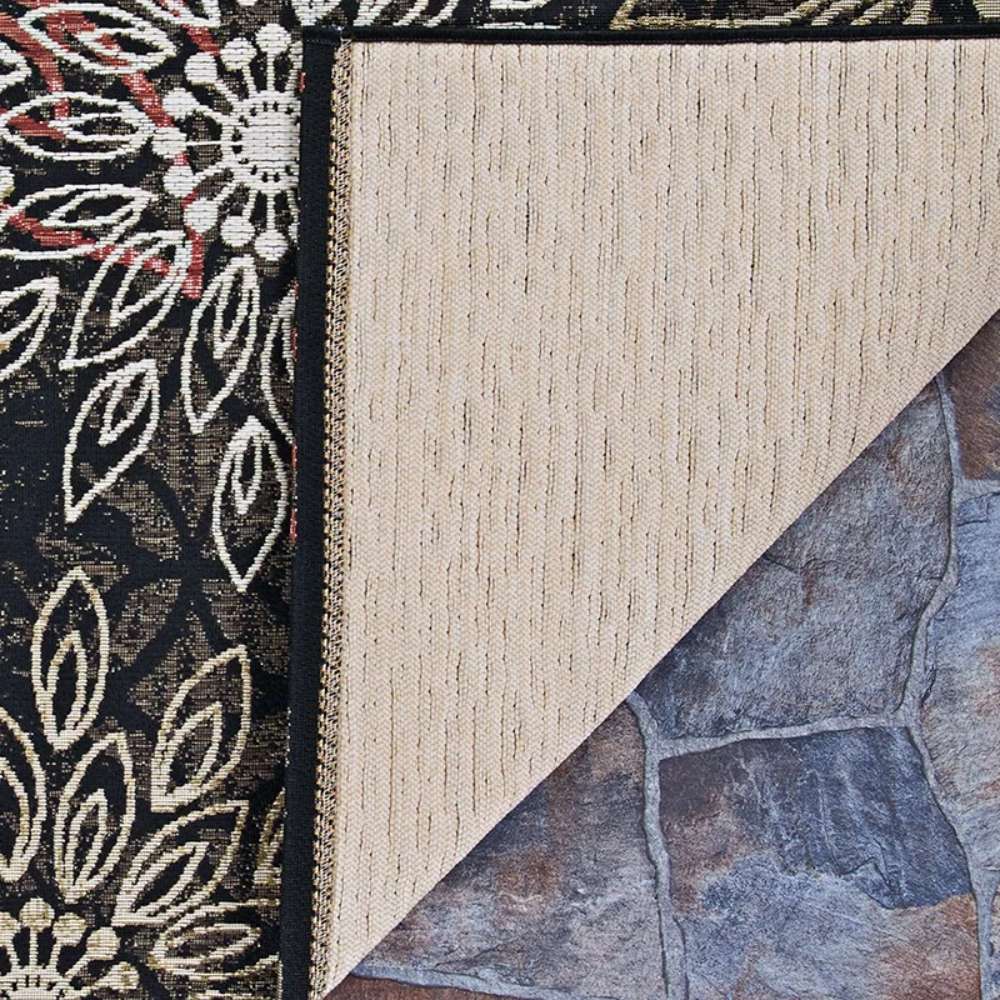 Close-up shows the corner of Couristan Dolce Indoor/Outdoor Rug - Amalfi/Multi flipped over, revealing its textured beige backing and durable weave