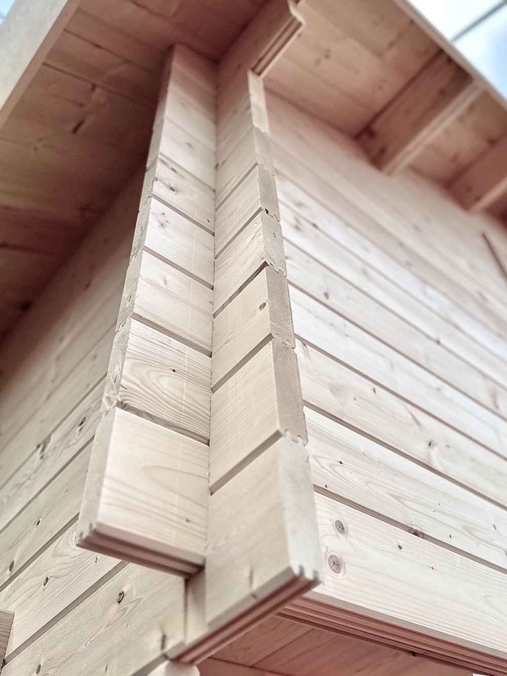 Close-up view of interlocking corner notches on a log wall shows the fine craftsmanship of the Sawmill Structures Ontario Grand Loft 107 SD Garden Room