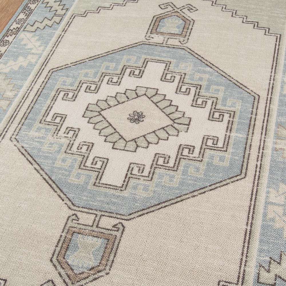 Close-up view of the geometric pattern in soft beige and blue on Momeni Anatolia Indoor Rug - ANA-2 Light Blue