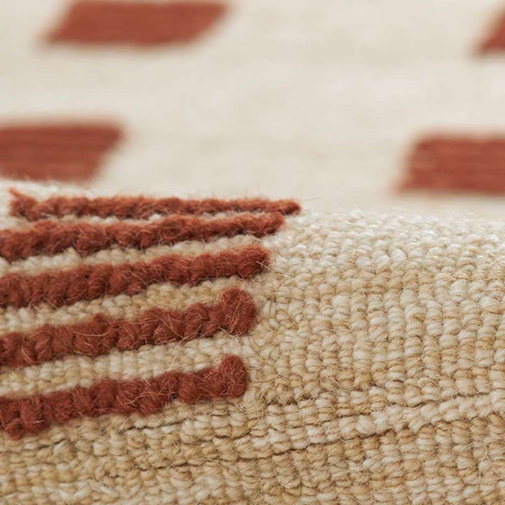 Close-up view of the textured weave and raised rust-colored square pattern on Momeni Archer Indoor Rug - ARC-1 Rust