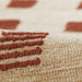 Close-up view of the textured weave and raised rust-colored square pattern on Momeni Archer Indoor Rug - ARC-1 Rust