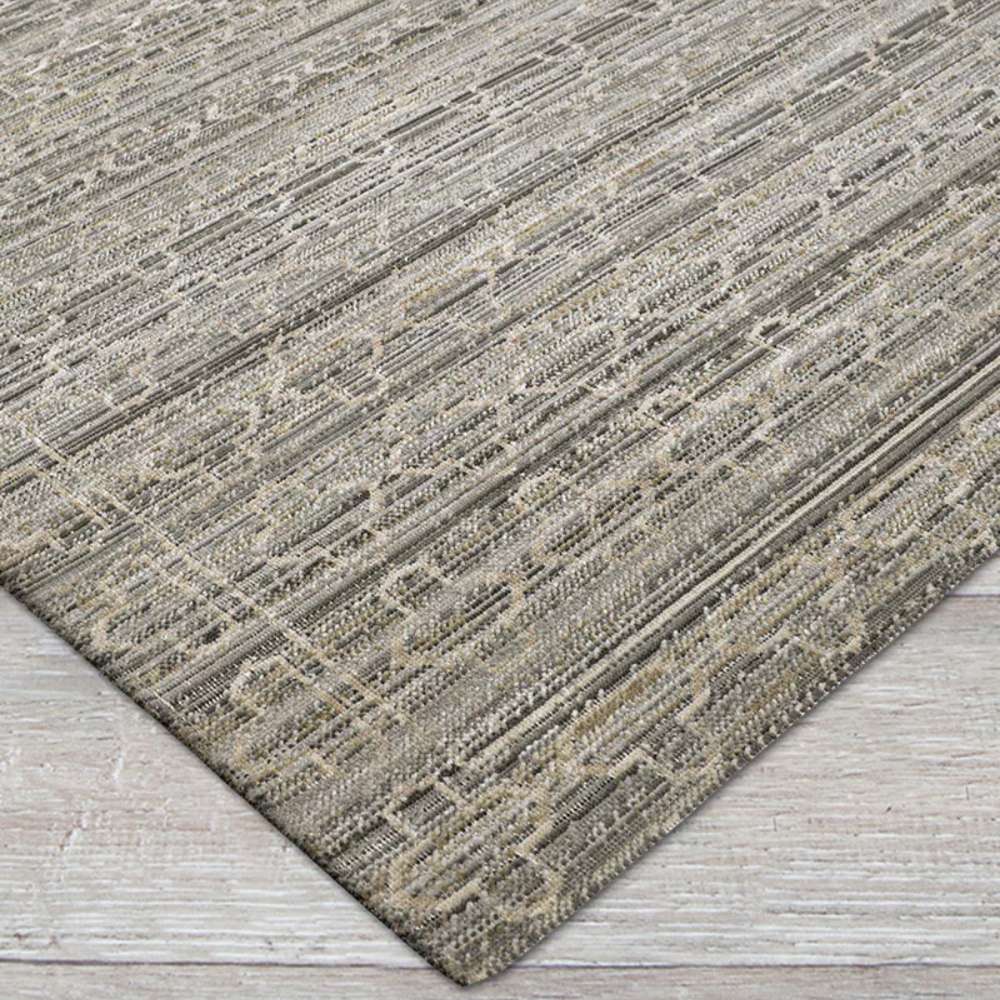 Close-up view shows Couristan Fez Indoor/Outdoor Rug - Riad/Ash with a soft ash-gray base and subtle geometric patterns woven across the surface