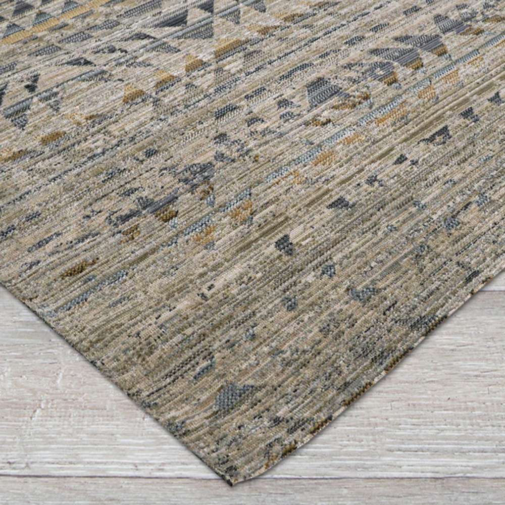 Close-up view shows the textured edge of Couristan Fez Indoor/Outdoor Rug - Souk/Earthen lying flat on a wooden floor