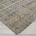 Close-up view shows the textured edge of Couristan Fez Indoor/Outdoor Rug - Souk/Earthen lying flat on a wooden floor