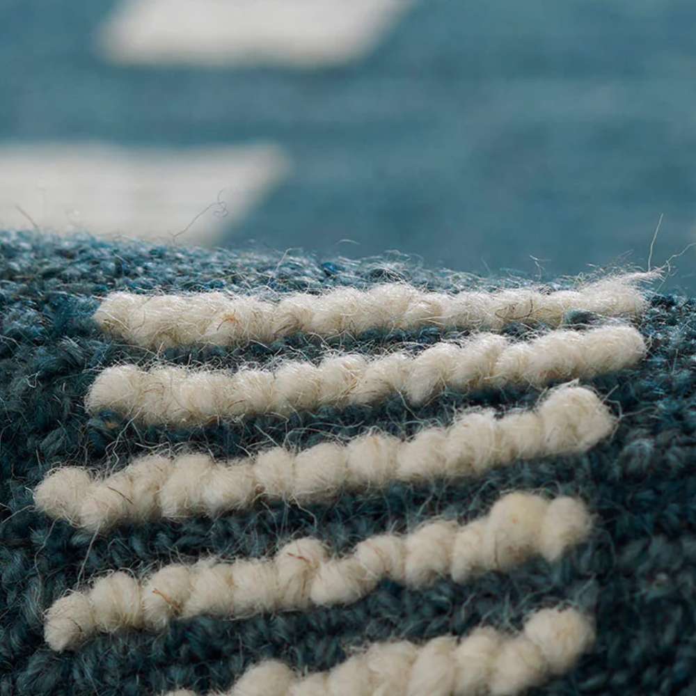 Close-up of Momeni Archer Indoor Rug - ARC-1 Blue highlights its textured white looped pattern against the deep blue background