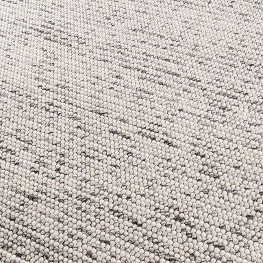 Close detail of Momeni Andes Indoor Rug - AND-8 Ivory showcasing its hand-felted wool loops in natural ivory shades