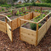 Colorful flowers and leafy vegetables grow inside an Outdoor Living Today 8×12 Raised Garden Bed with open wooden fencing and a front gate