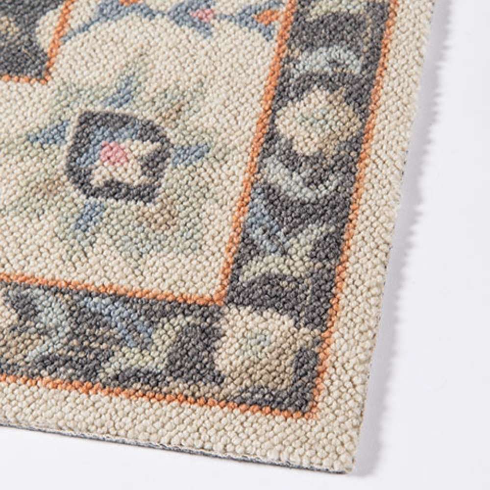 Corner edge of Momeni Anatolia Indoor Rug - ANA-8 Charcoal displays its clean finish and intricate border design