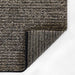 Corner fold of Momeni Andes Indoor Rug - AND-8 Charcoal reveals its durable backing and clean edging